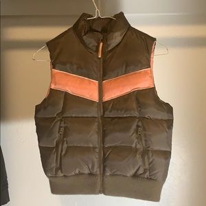 Brown vest with pink inside.